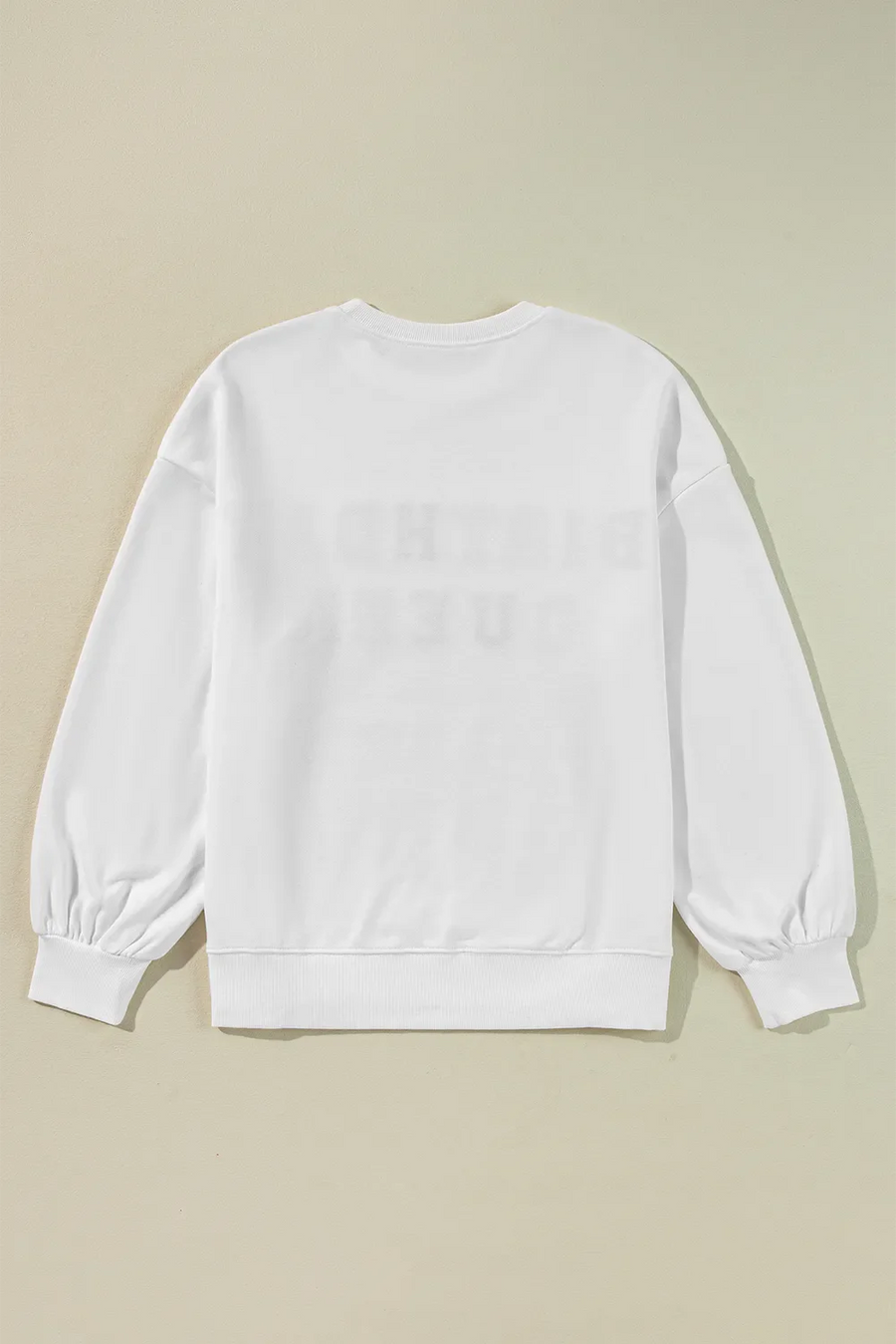 White sweatshirt with puff sleeves and "Birthday Queen" graphic