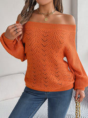 Pumpkin open-knit off-shoulder sweater with voluminous sleeves and intricate leaf pattern.