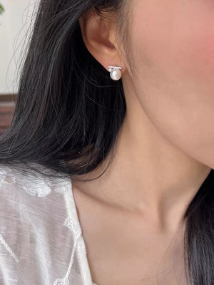 White pearl stud earrings with a bar of clear zircon accents.