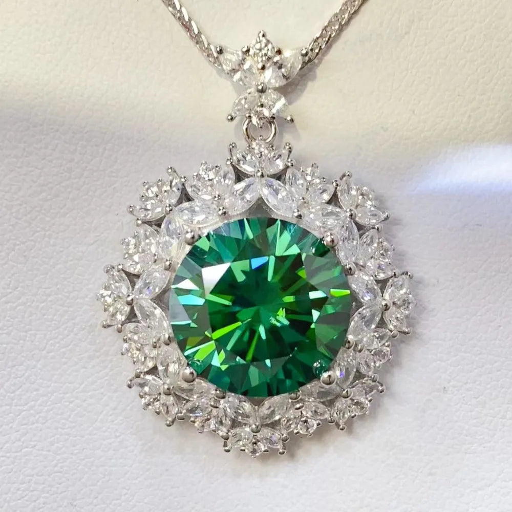 Emerald halo moissanite statement necklace in silver with a large green center stone and clear accent stones.