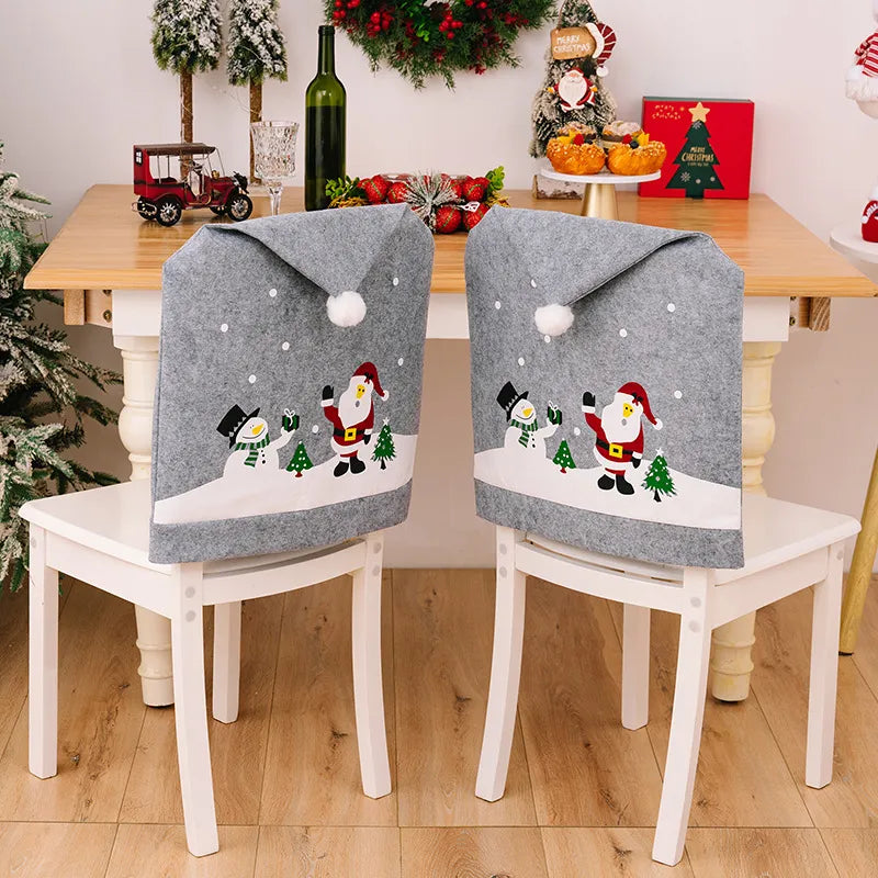 Gray chair cover with Santa and snowman applique, pom-pom top, and falling snow detail.