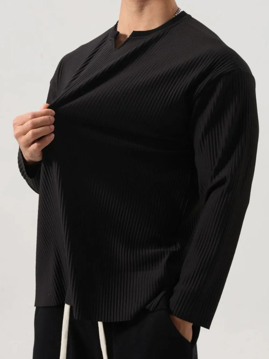 Black textured plissé long sleeve henley top with a notched neckline.