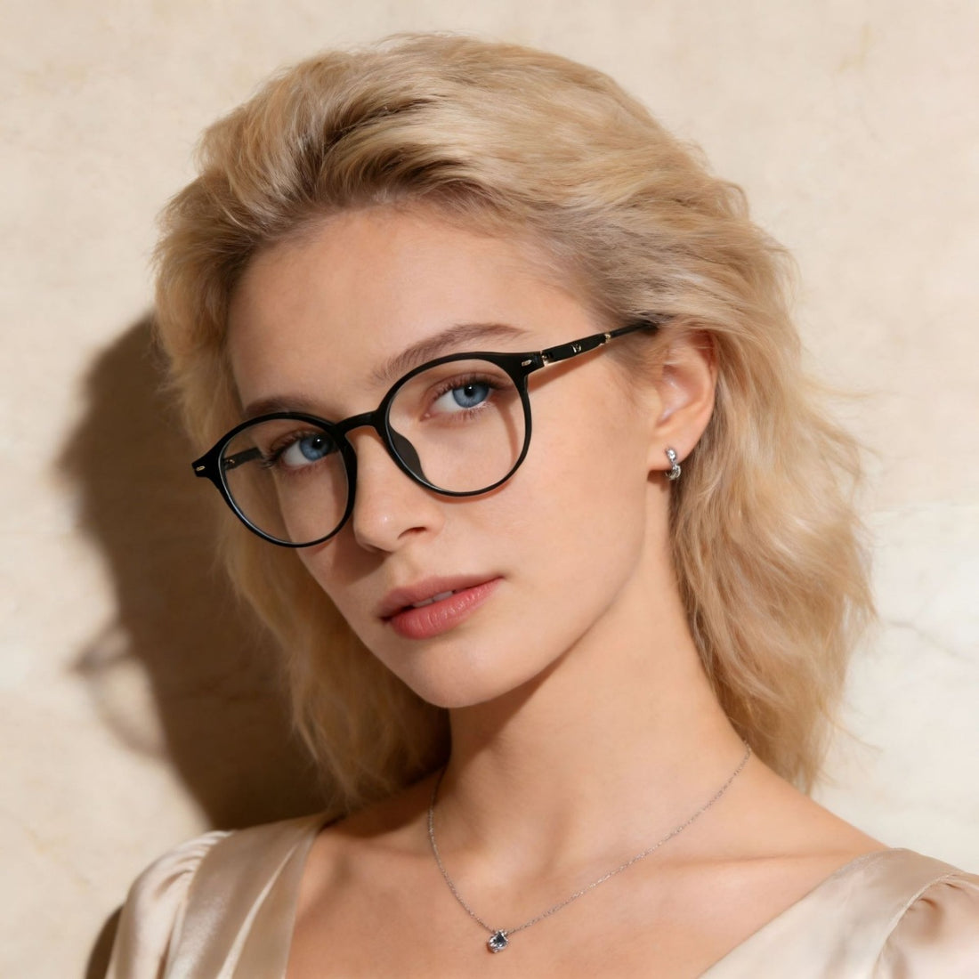 Black acetate round frame glasses with clear lenses on a woman.