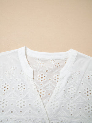 White cotton eyelet embroidered sheer shirt with floral details and a V-neck.