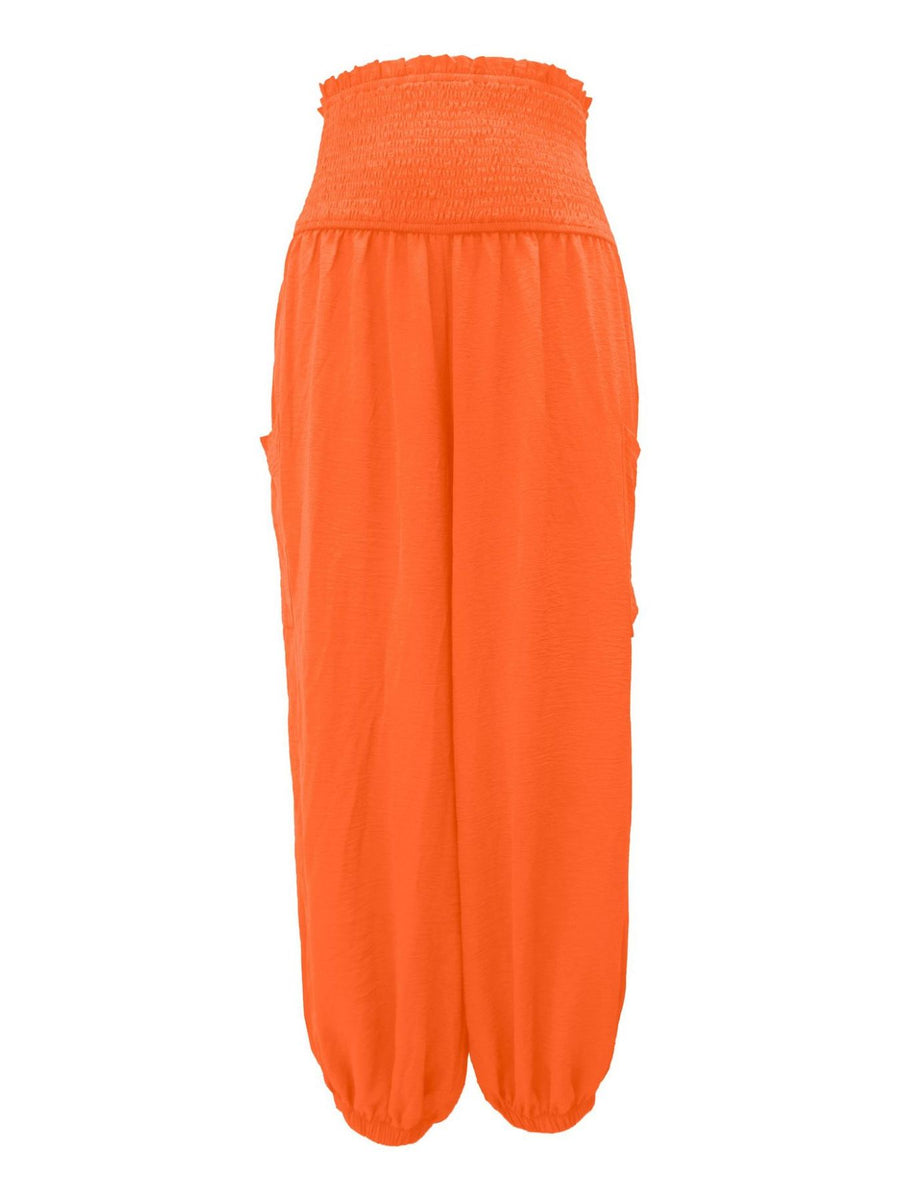Orange smocked waist harem pants with pockets and ankle cuffs.