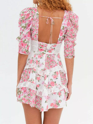 Ruched floral tie-front mini dress with lace trim and puff sleeves.