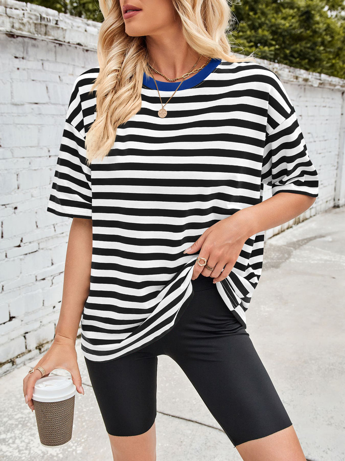 Relaxed fit black and white striped t-shirt with contrast blue trim and short sleeves.