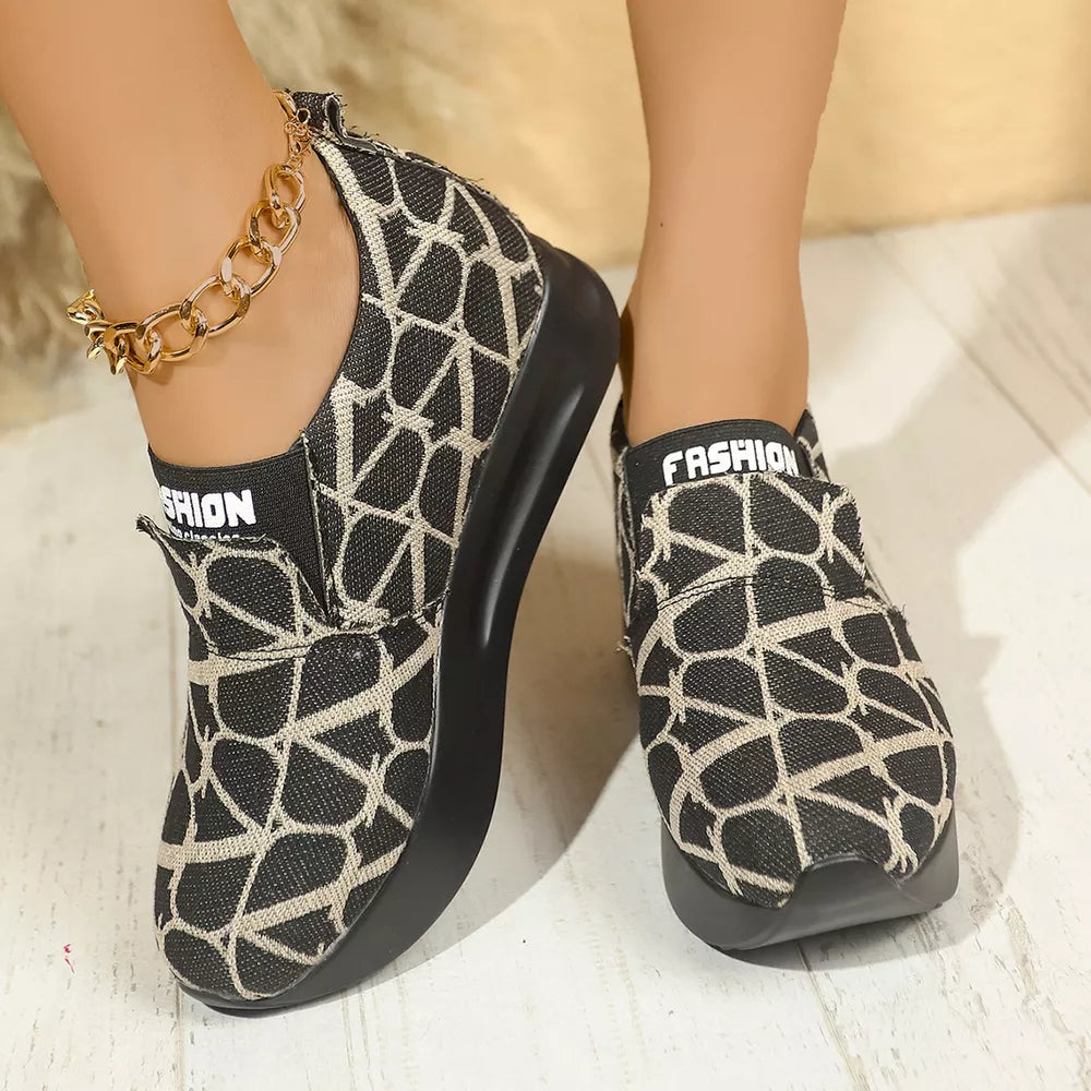 Geometric patterned black and beige slip-on platform sneakers with "FASHION" detail.
