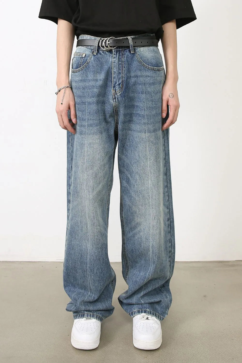 Wide-leg washed denim jeans in medium blue, relaxed fit, with a distressed look.
