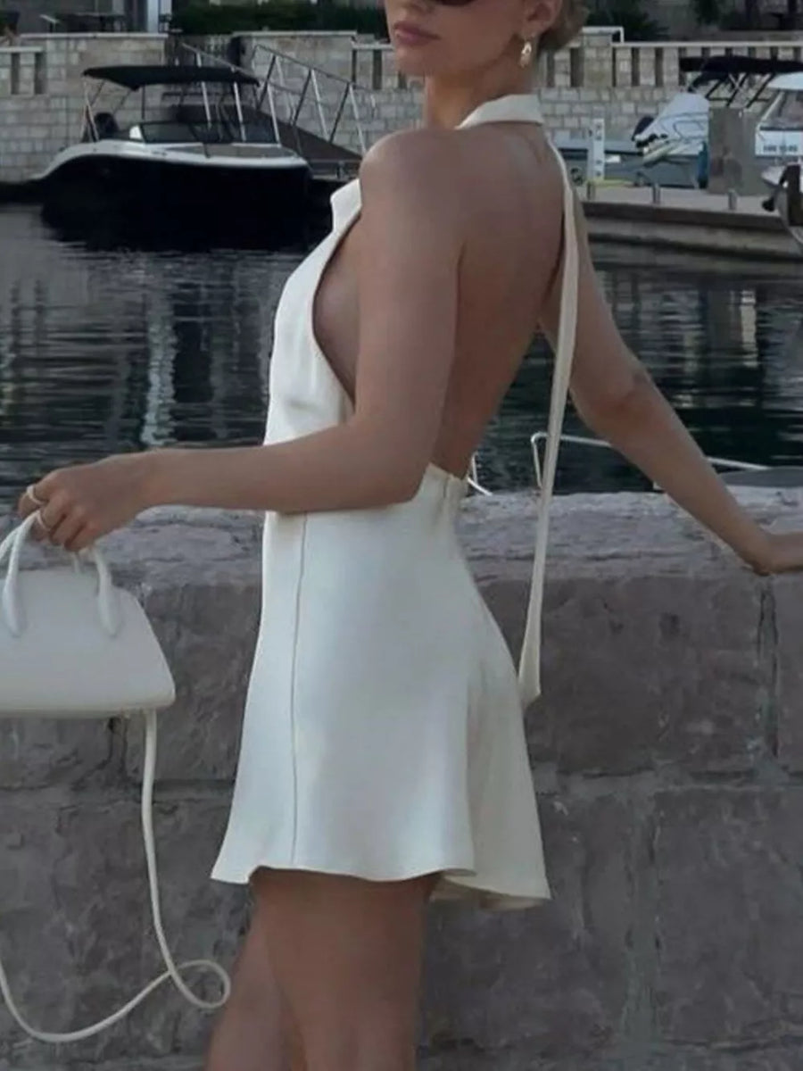 White halter neck mini dress with open back and tie detail