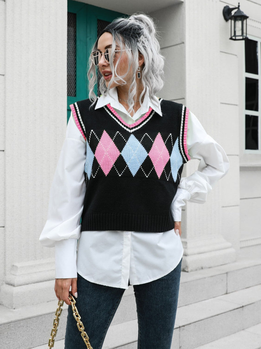 Argyle knit sweater vest with pink and blue diamonds and pink trim.