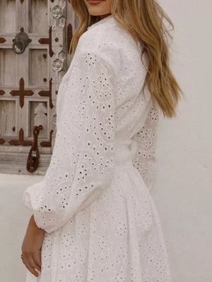 White eyelet balloon sleeve mini dress with detailed embroidery.