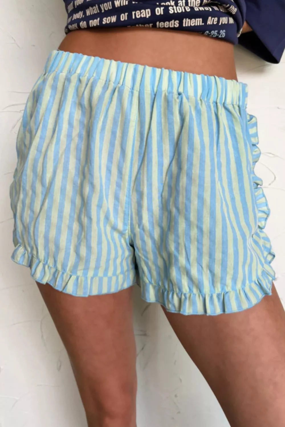 Ruffled striped cotton shorts in blue and light green with an elastic waist.
