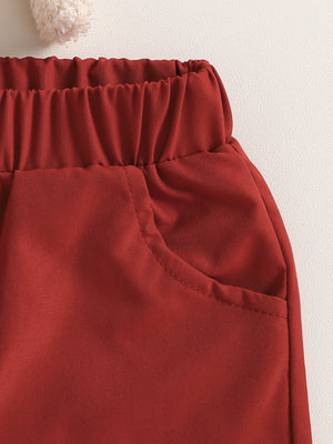 Toddler red cotton pants with elastic waist and pocket detail.