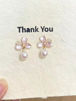 Charming pearl blossom drop earrings with delicate pink petals and sparkling accents.