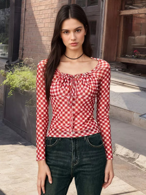 Red gingham tie-front long sleeve maternity shirt with square neckline.