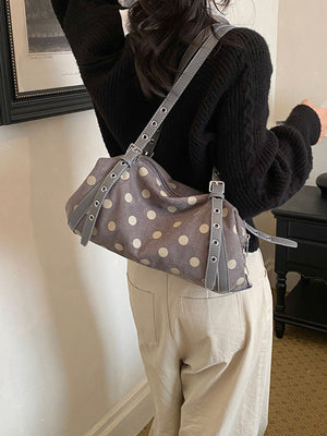 black shoulder bag featuring polka dot print and polka dot