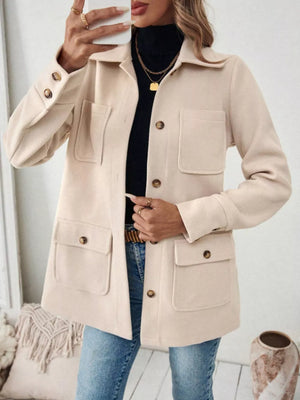 Chic apricot button-front trench coat with four pocket details and buttoned cuffs.
