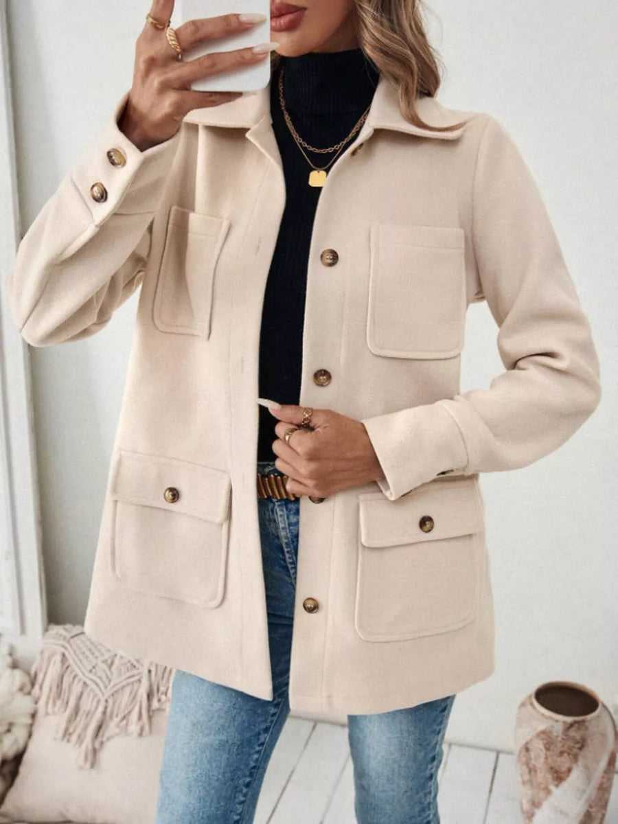 Chic apricot button-front trench coat with four pocket details and buttoned cuffs.