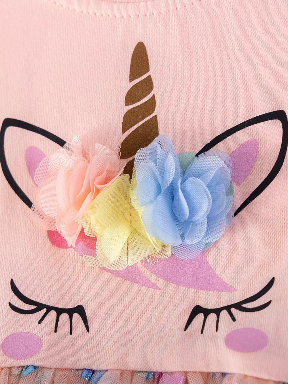 Pink unicorn dress with floral applique and ruffled trim.