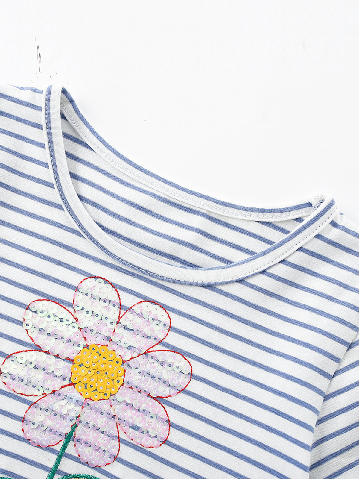 Toddler striped dress with sequin flower applique detail.