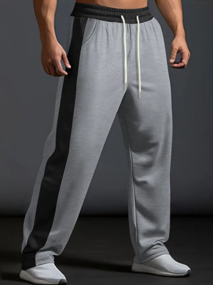 Gray track pants with black side panel detail and drawstring waist.