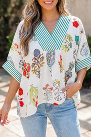 Vibrant floral print shirt with green striped contrast trim and V-neck.