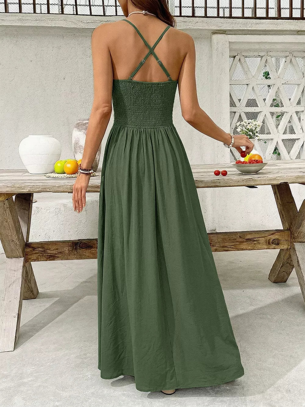 Green cotton blend maxi dress with spaghetti straps and smocked bodice.