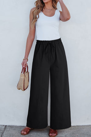 Black cropped drawstring pants with elastic waist and wide legs.