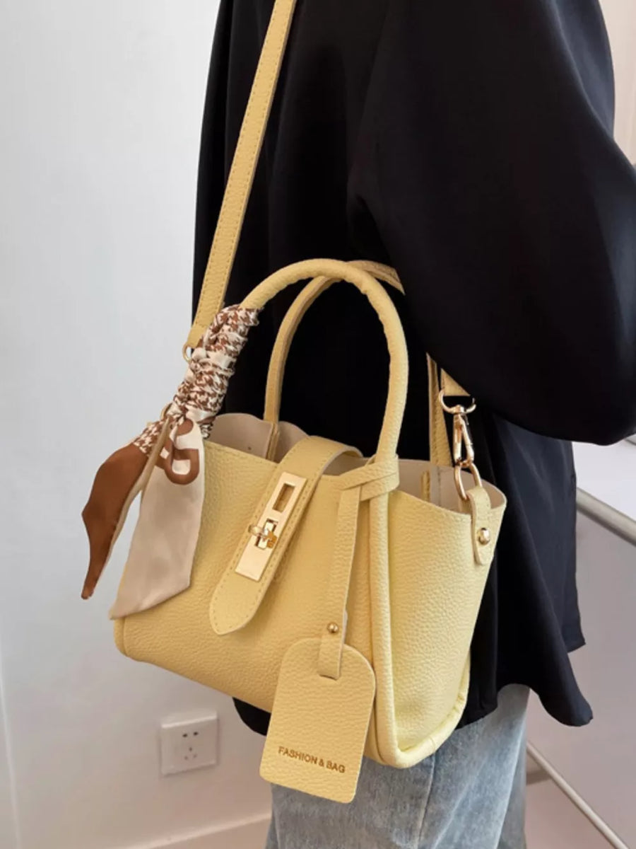 Yellow mini crossbody bag with scarf detail and gold hardware