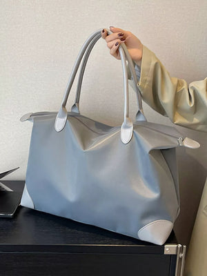 Grey Oxford cloth travel tote bag with light grey accents and double handles.