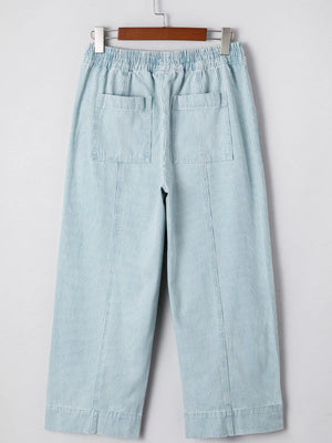 Light blue striped cotton blend drawstring jeans with elastic waist and back pockets.