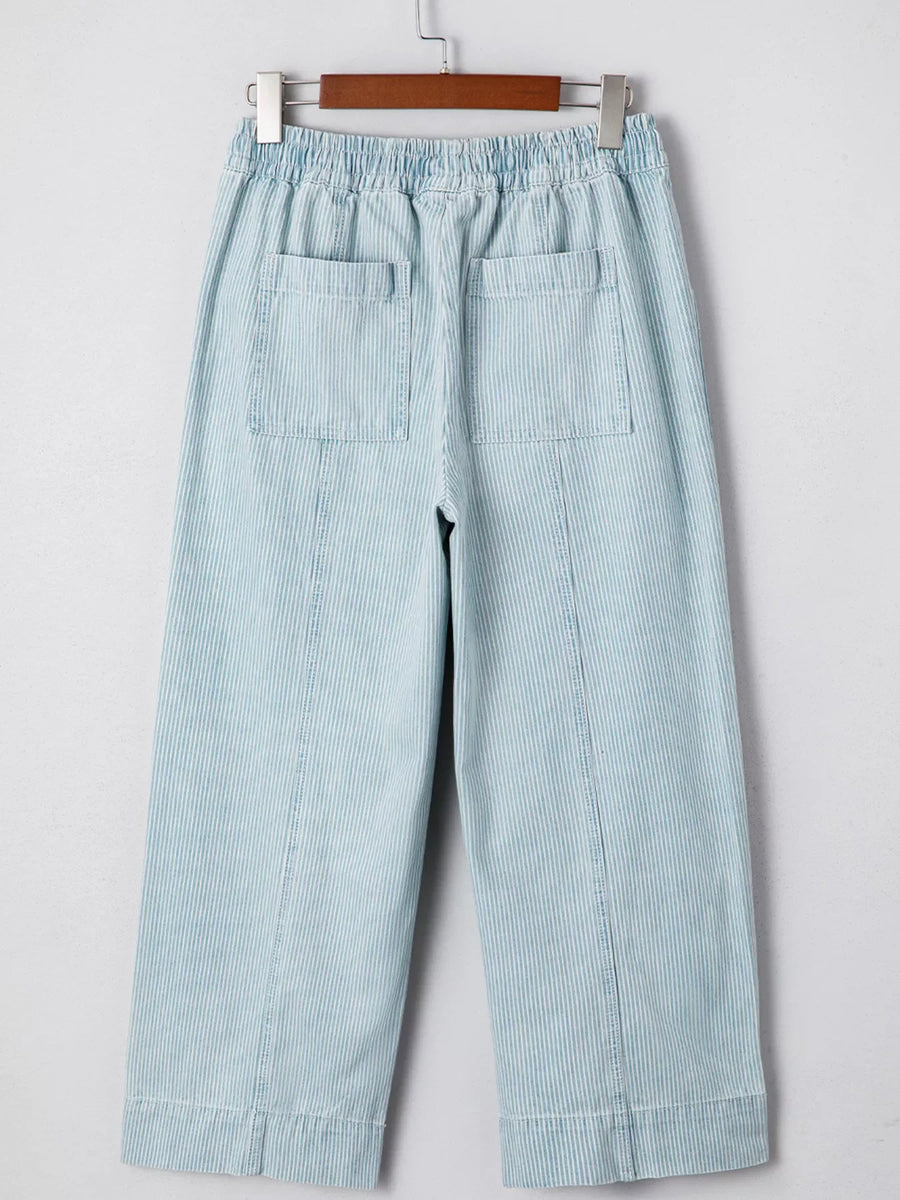 Light blue striped cotton blend drawstring jeans with elastic waist and back pockets.