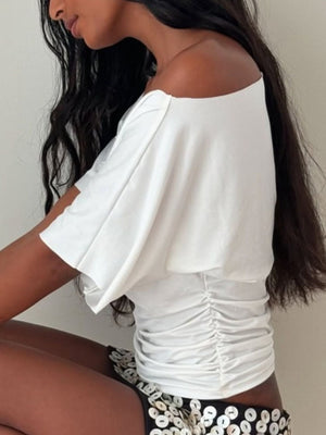 White ruched one shoulder t-shirt with short sleeves and asymmetrical neckline.