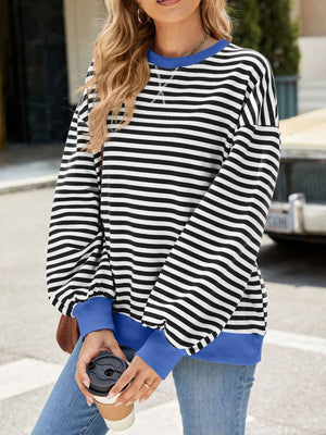 Striped crew neck sweatshirt with royal blue cuffs and neckline.