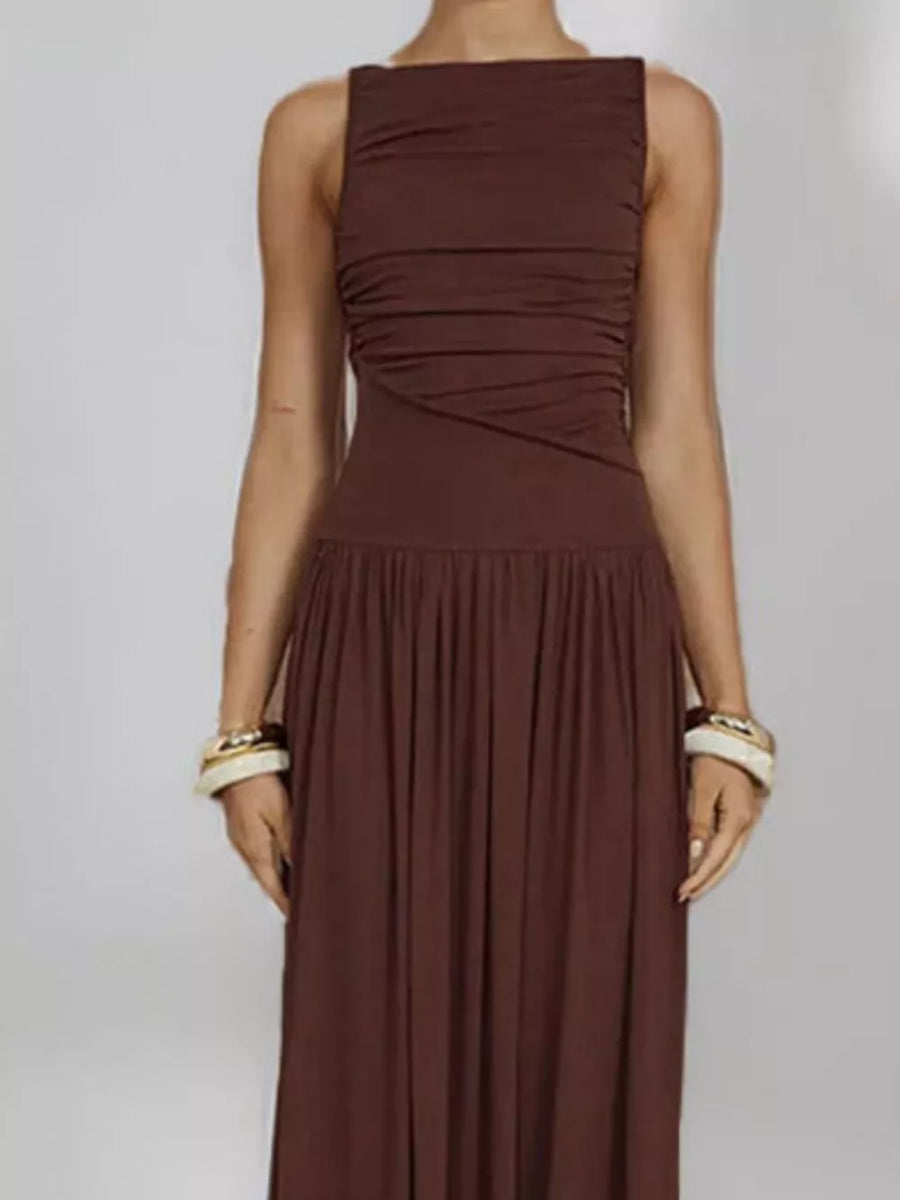 Brown ruched maxi dress with gathered neckline and full skirt.