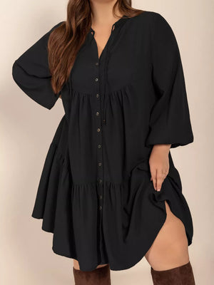 Black plus-size balloon sleeve dress with button front and tiered skirt.