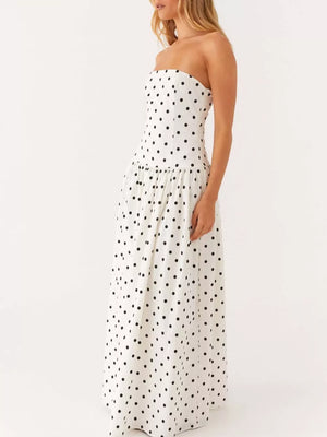 White polka dot strapless maxi dress with a tiered skirt.