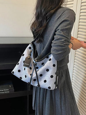 handbag in black with polka dot and shoulder strap