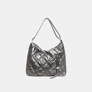 Gray diamond quilt padded shoulder bag with zipper detail and tassel.