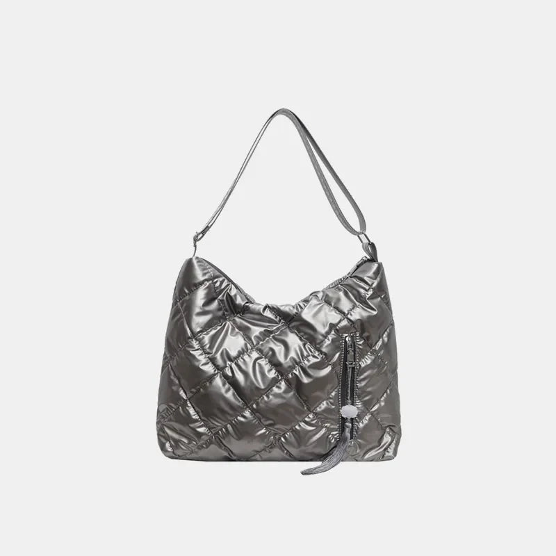 Gray diamond quilt padded shoulder bag with zipper detail and tassel.