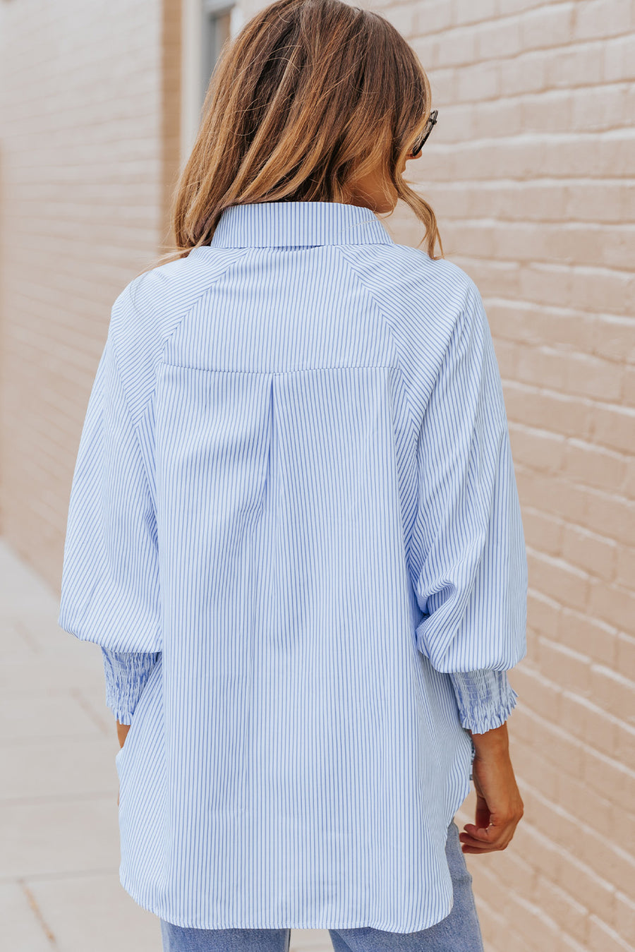 Pastel blue pinstripe blouse with balloon sleeves and smocked cuffs.