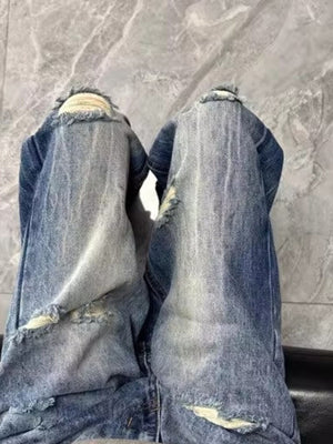 Men's blue distressed baggy jeans with visible pocket details and frayed hems.