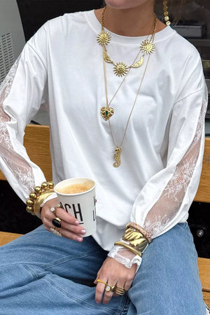 White long sleeve shirt with lace panel sleeves and crew neckline.