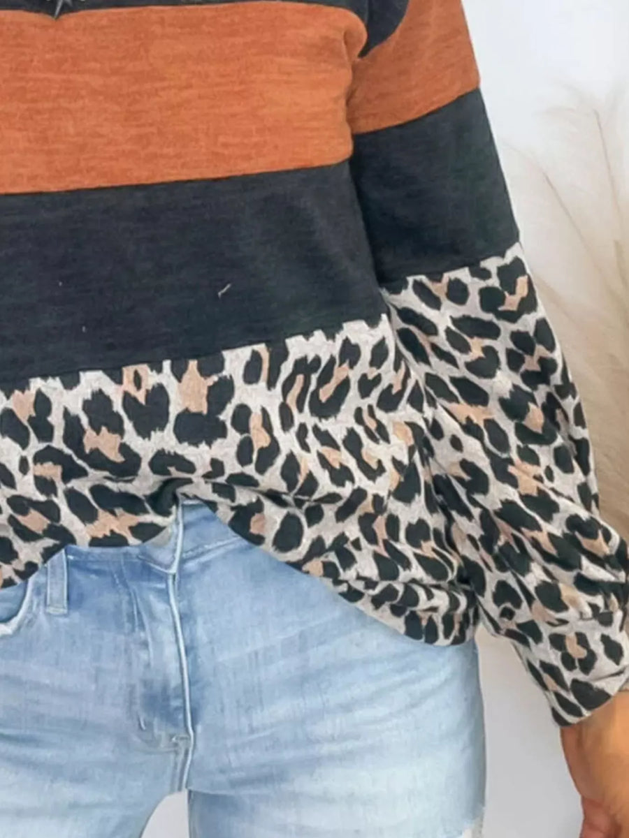 Leopard print patchwork blouse with colorblock design in rust and black.