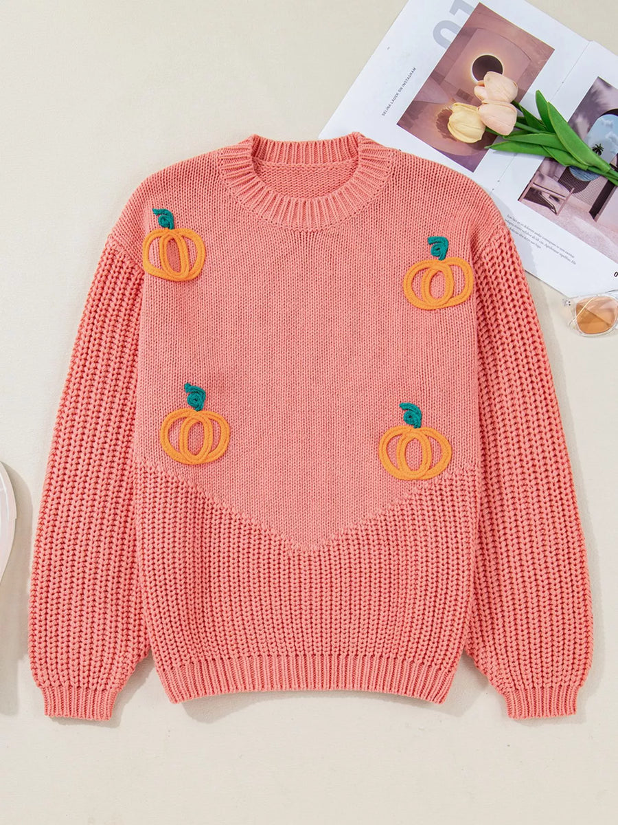Embroidered pumpkin sweater in burnt coral with a crew neck and ribbed details.