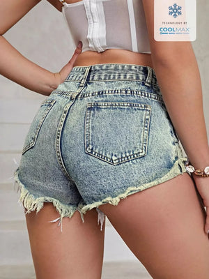 High-waisted distressed denim shorts in Vintage Washed Blue with frayed hem and COOLMAX technology.