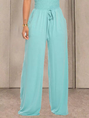 Aqua wide leg pants with smocked waist and drawstring, featuring pockets.
