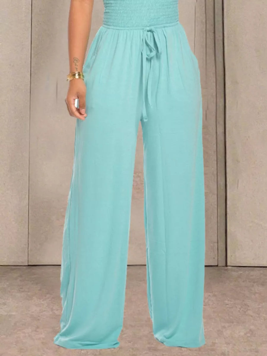 Aqua wide leg pants with smocked waist and drawstring, featuring pockets.