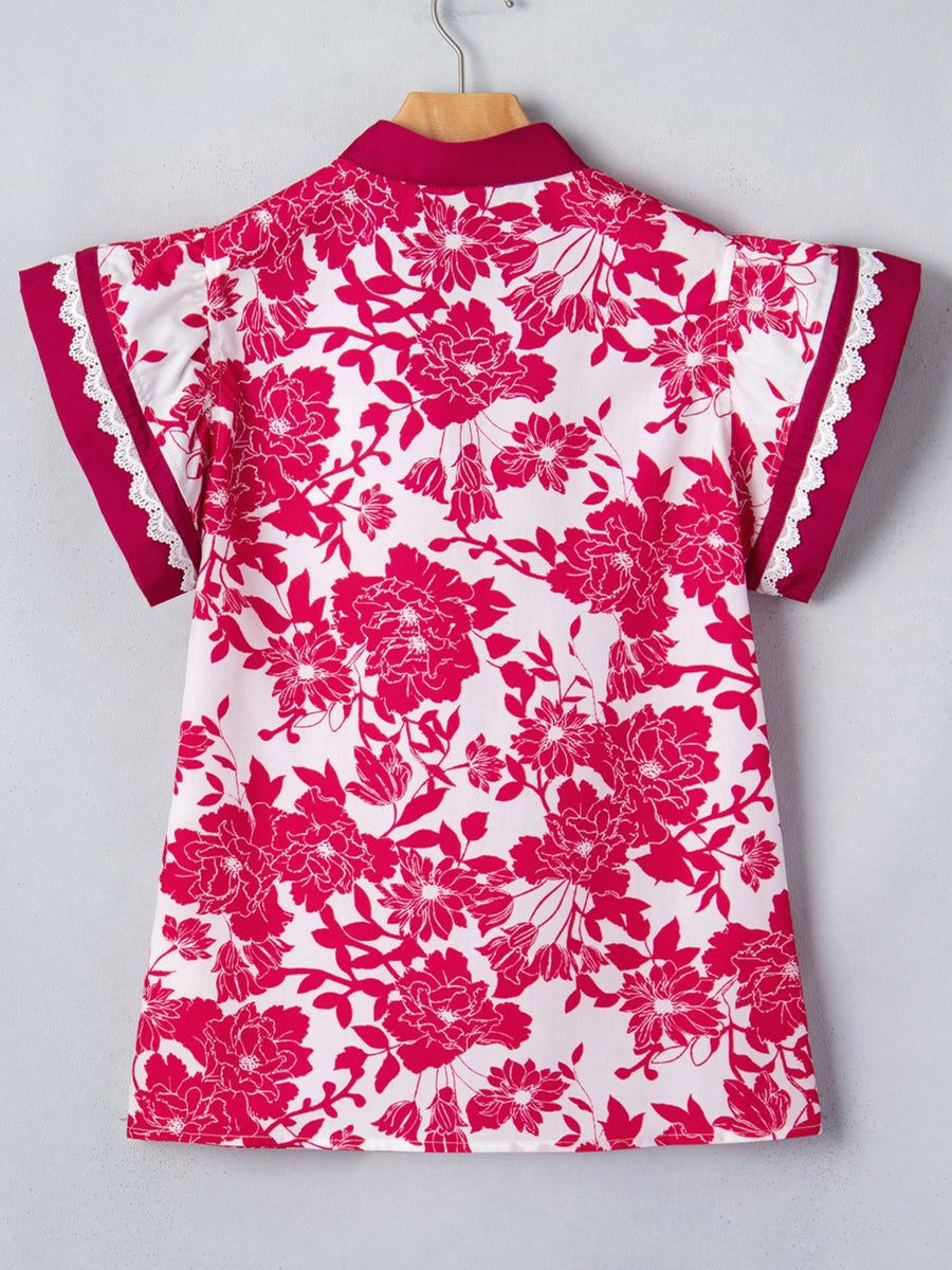 White polyester blouse with a bold pink floral print, lace trim on sleeves, and a stand collar.